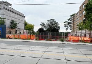 A nine-storey condo is proposed for this site on the south side of Kingston Road just west of Lee Avenue, though construction has stopped and the site is now a large hole in the side of the hill sloping south. Photo by Alan Shackleton.