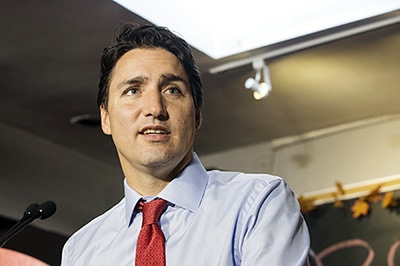 Trudeau speaks to supporters gathered at a Queen Street cafe on the morning of Oct. 13. Joining Trudeau were local Liberal candidates Nathaniel Erskine-Smith, who is running in Beaches-East York, and Bill Blair, who is running in Scarborough-Southwest. PHOTO: Victor Biro