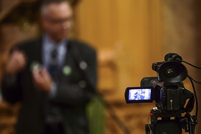 Green Party candidate Randall Sach is seen on the monitor of a TV camera during the Sept. 29 debate at St. John Norway church. PHOTO: Victor Biro