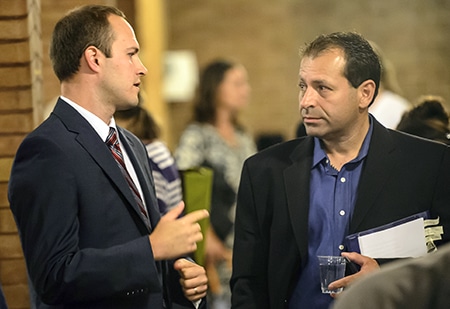 Liberal candidate Nathaniel Erskine-Smith speaks with  Conservative candidate Bill Burrows following the candidates' debate at St. John Norway church. PHOTO: Victor Biro