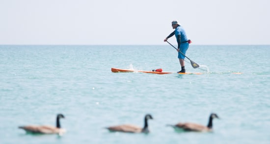Trevor Petersen tests the water at Balmy Beach a week before launching a month-long paddleboarding expedition from Toronto to Ottawa, all to raise awareness for people who suffer from post-traumatic stress disorder. A former member of the Canadian Forces, Petersen was diagnosed with PTSD after returning from Afghanistan in 2007 and says paddleboarding helped with his recovery. "The first or second time I was on a paddleboard, it was like, 'This is what it is – this is what it's like to be in the moment,'" he said. "All the background noise that was constantly going with the PTSD, it just stopped." PHOTO: Andrew Hudson