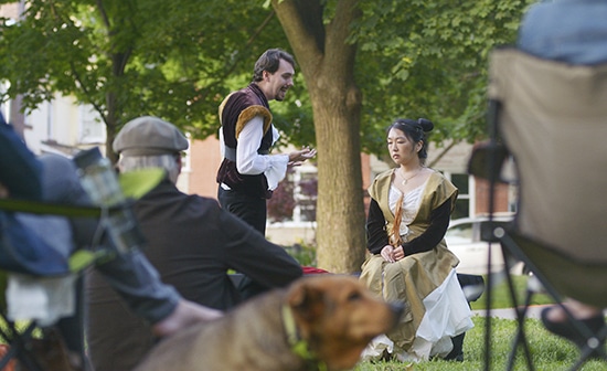 Laertes, played by Caedmon Ricker-Wilson, speaks to Ophelia, played by Olivia Jon, during Bard in the Park's opening night performance of Hamlet at Norwood Park. PHOTO: Jon Muldoon