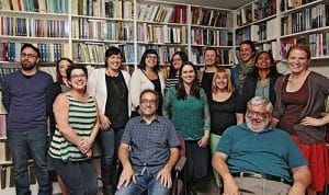 Co-publishers Jack David, front right, and David Caron, front left, gather with ECW Press staff in the local publisher’s in-house library. ECW recently celebrated 40 years in Canadian publishing, as well as the selection of two of its authors for the Giller Prize long list. PHOTO: Andrew Hudson