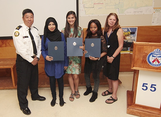 From left, Superintendent Peter Yuen stands with local high school graduates Emman Haider, Kendall Mar, Ruth Kayembe, and Community Centre 55's Nancy Culver on June 19 after the students were awarded scholarships from 55 Division's Community Police Liason Committee. PHOTO: Andrew Hudson