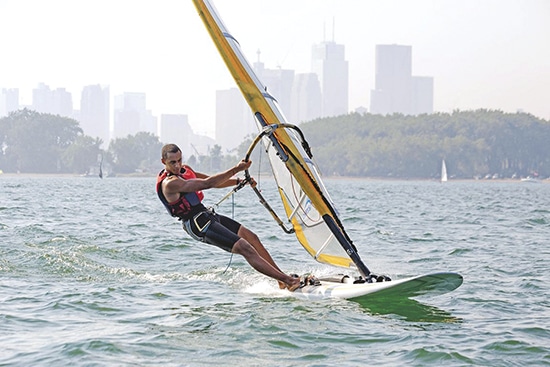 Max Robinson windsurfs off Cherry Beach while training at the Toronto Windsurfing Club last year. The 21 year-old Beach resident has competed in several international regattas on the Olympic-class RS:X, and is campaigning for a spot at the 2015 Pan Am and 2016 Olympic Games. PHOTO: Toronto Windsurfing Club