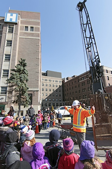 AMEC engineer Michael Salter talks to Grade 1 and 2 students from nearby RH McGregor Public School on April 16 about the test drilling underway at the future site of Toronto East General's new patient tower. PHOTO: Andrew Hudson
