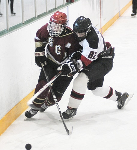 At top, Malvern’s Will McLean works to steal the puck from a Silverthorn CI player. Above, Braden Ream-Neal defends against Silverthorn during the Black Knights’ 4-1 city championship win at North Toronto Arena. PHOTO: Jon Muldoon