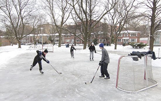 From left, Malvern students Austin, Jacob, Marshall and Jake play shinny on the Love Crescent Parkette rink on Dec. 19. At left, the volunteers who spray, flood, shovel and scrape the rink into shape take a timeout for a team photo. PHOTO: Andrew Hudson