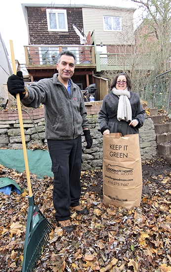 Hamid Ghassemi-Shall and Antonella Mega rake leaves outside their Beach home on Nov. 30. Hamid returned to Toronto on Oct. 10, more than five years after he was wrongfully imprisoned in Iran while visiting family. PHOTO: Andrew Hudson