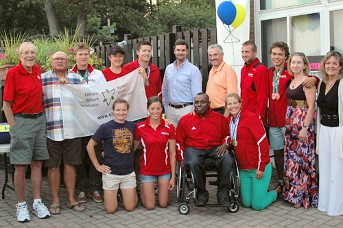 Members of the Balmy Beach Canoe Club celebrate the 2012-2013 paddling season at the Balmy Beach Club on August 20. Trillium Foundation grant Derek Nighbor, back row centre, and MPP Michael Prue, fifth from right, both spoke at the annual Commodore's Night—a $149,200 Trillium Grant allowed the club to add new boats to its fleet as well as a new truck for travelling to venues outside Ashbridges Bay. PHOTO: Submitted