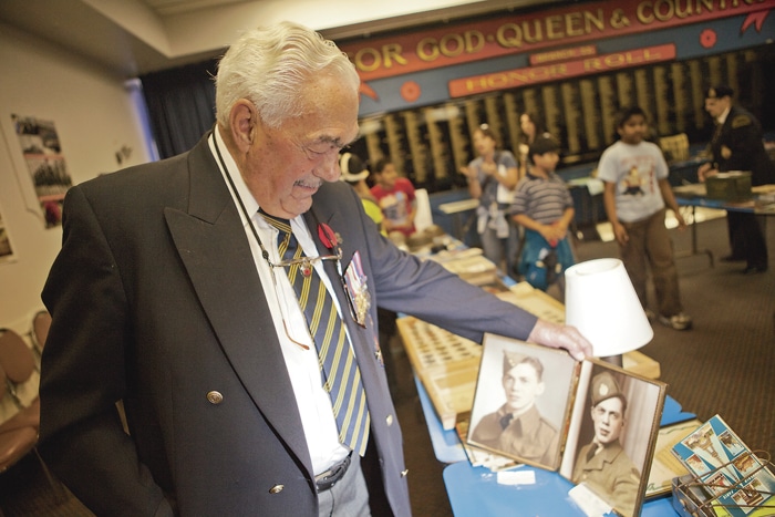 Joe Gagne contemplates photos of himself as a younger man. PHOTO: Phil Lameira / Beach Metro News