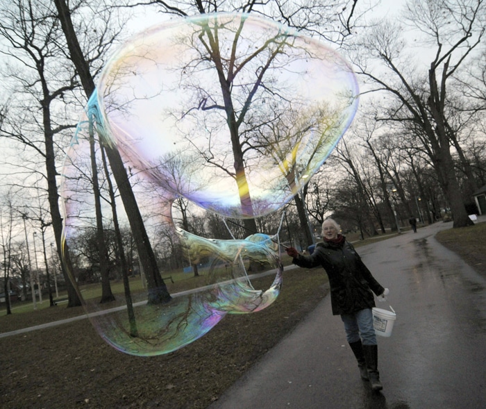 Mairead Lavery adds a little magic to Kew Gardens with a special mixture that helps her create giant, iridescent bubbles. PHOTO: Jon Muldoon / Beach Metro News