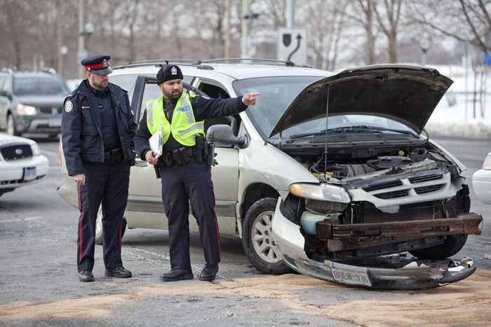 Police investigate the scene of a crash at Lakeshore and Coxwell after a suspected stolen van ran through a red light. The suspects fled on foot and are still at large. PHOTO: Phil Lameira / Beach Metro News