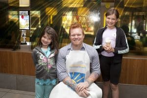 McHappy Day in the Beach Paralympian Jeff Adams, who has won three gold, four silver, and six bronze medals, poses with sisters Sarah, 6, and Melissa Harvey, 9. PHOTO: PHIL LAMEIRA / BEACH METRO NEWS